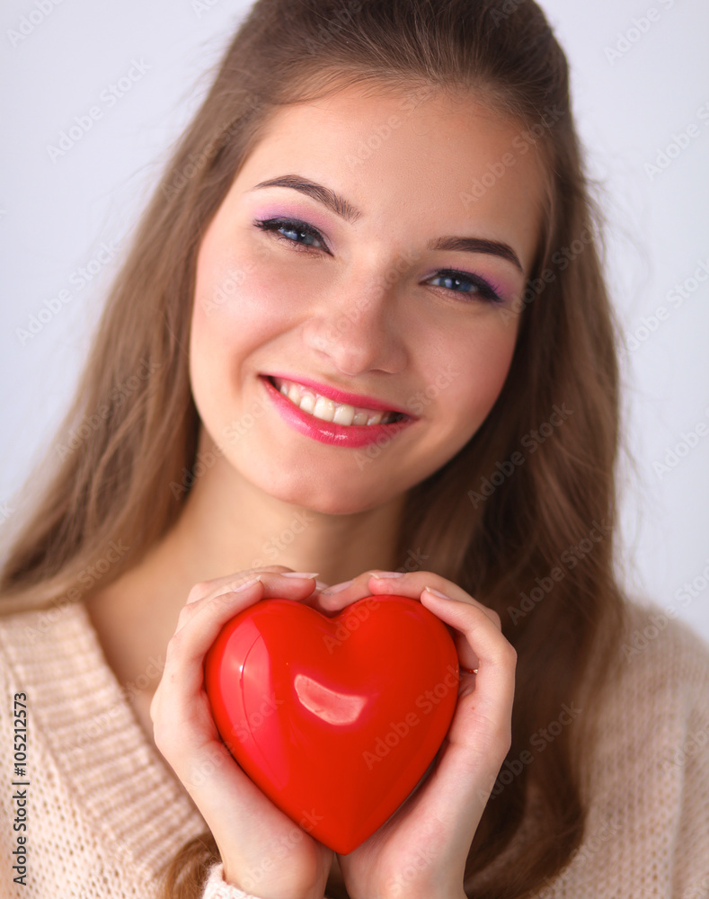 Portrait of beautiful happy woman holding a symbol heart. Portrait of beautiful happy woman holding a symbol heart.