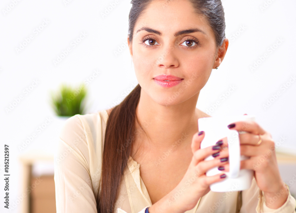 Beautiful businesswoman enjoying coffee in bright office Beautiful businesswoman enjoying coffee in bright office