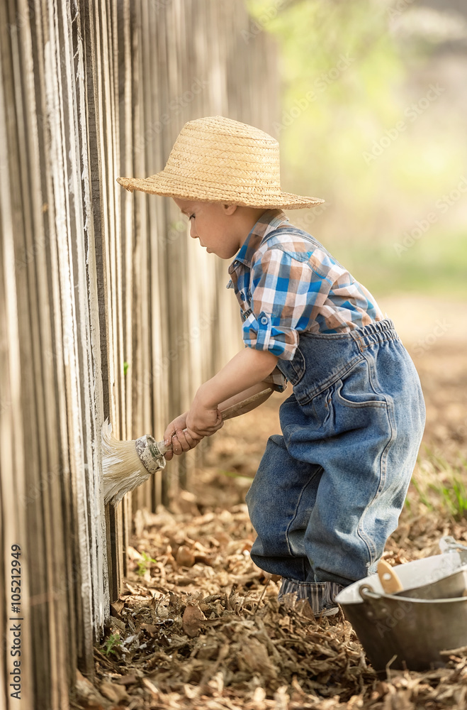 Boy paint old fence