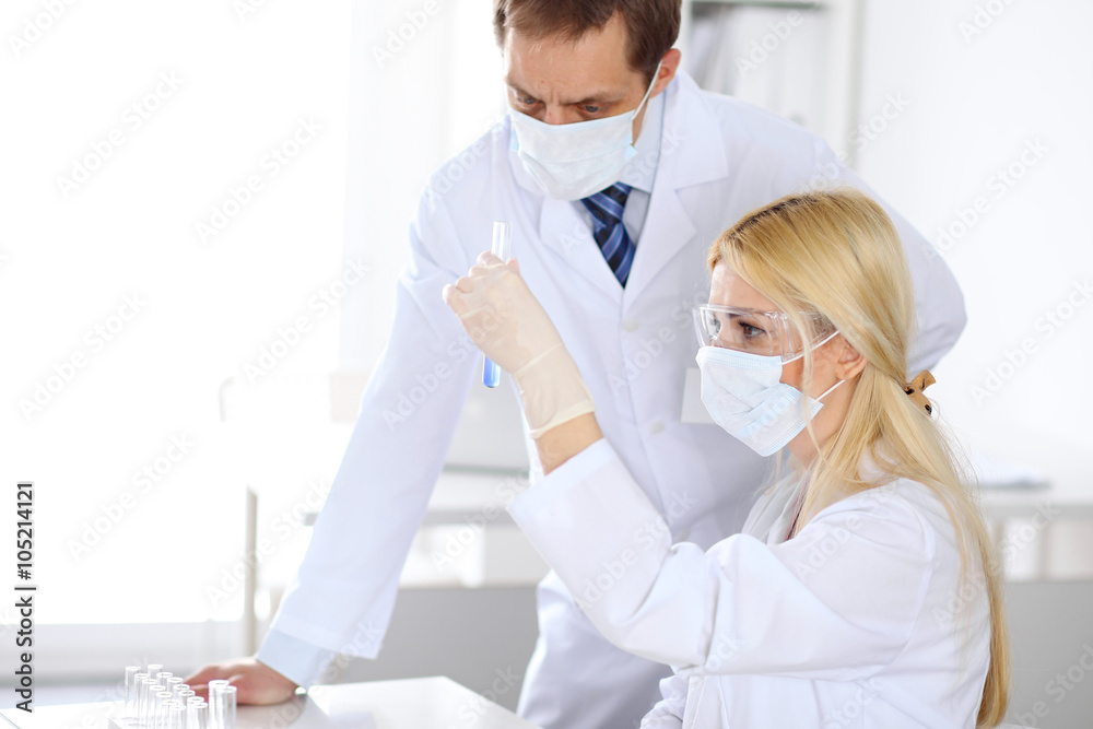 Scientific research team with clear solution in laboratory Scientific research team with clear solution in laboratory
