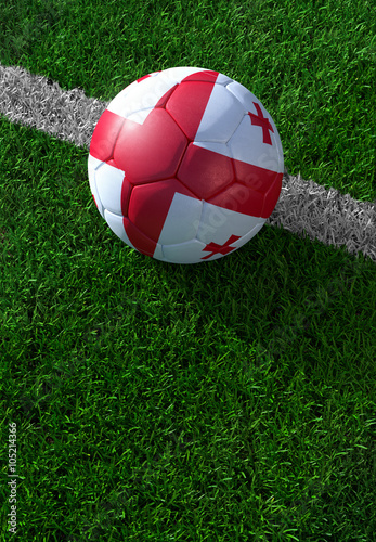 Soccer ball and national flag of Georgia, green grass