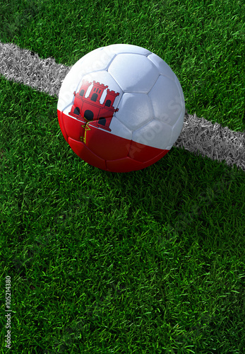 Soccer ball and national flag of Gibraltar   green grass