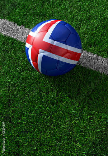 Soccer ball and national flag of Iceland, green grass