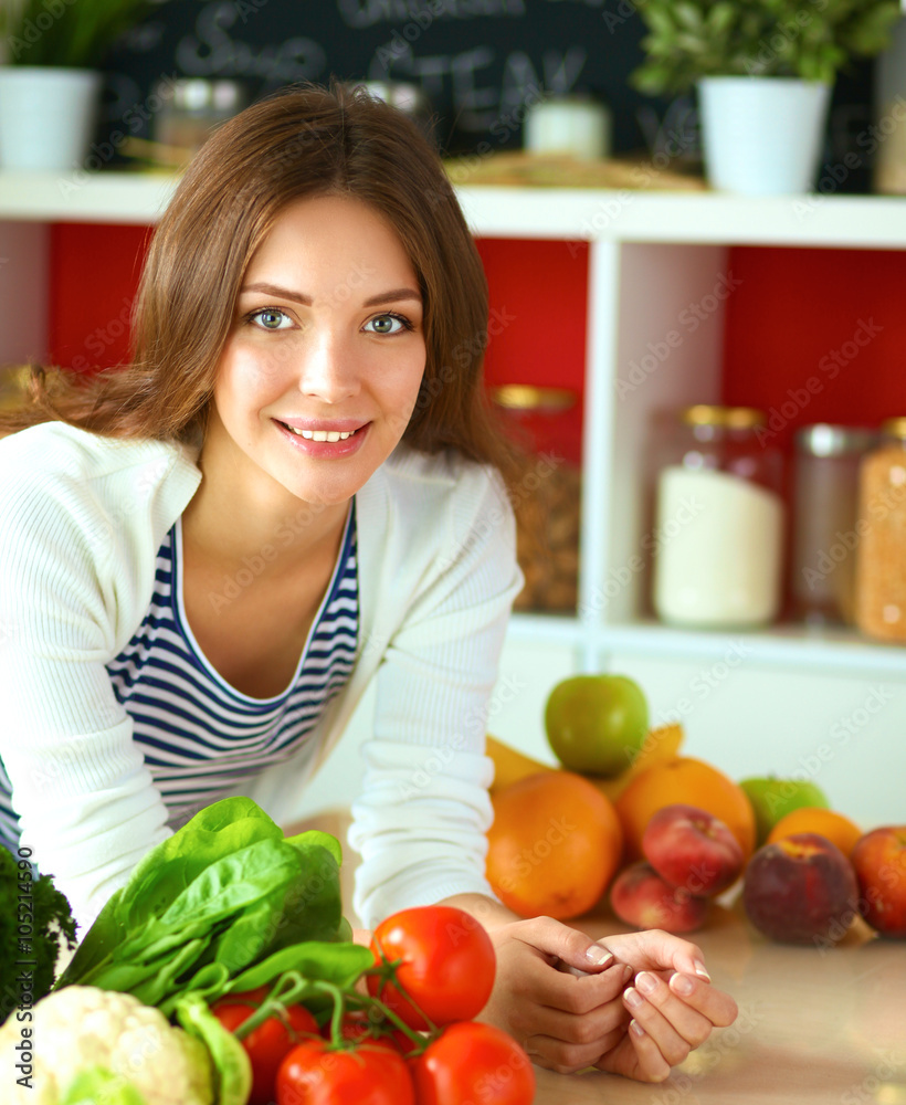 Young woman sitting near desk in the kitchen Young woman sitting near desk in the kitchen