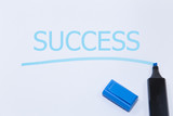 success word with blue marker on white background