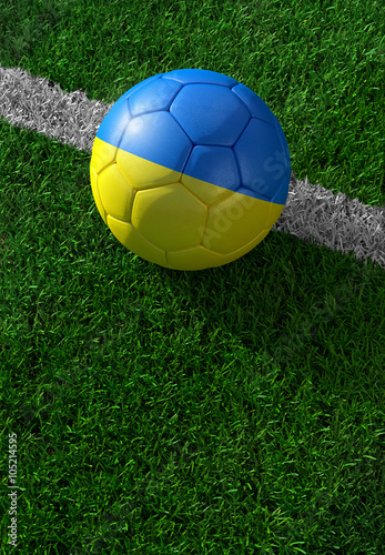 Soccer ball and national flag of Ukraine   green grass