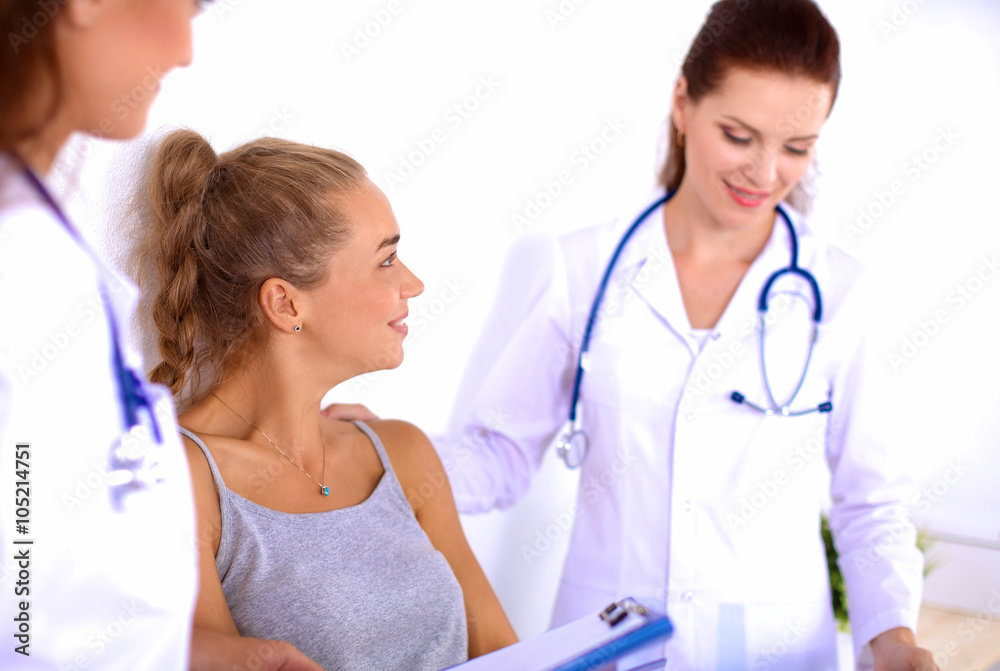 Smiling female doctor with a folder in uniform standing at hospital Smiling female doctor with a folder in uniform standing at hospital