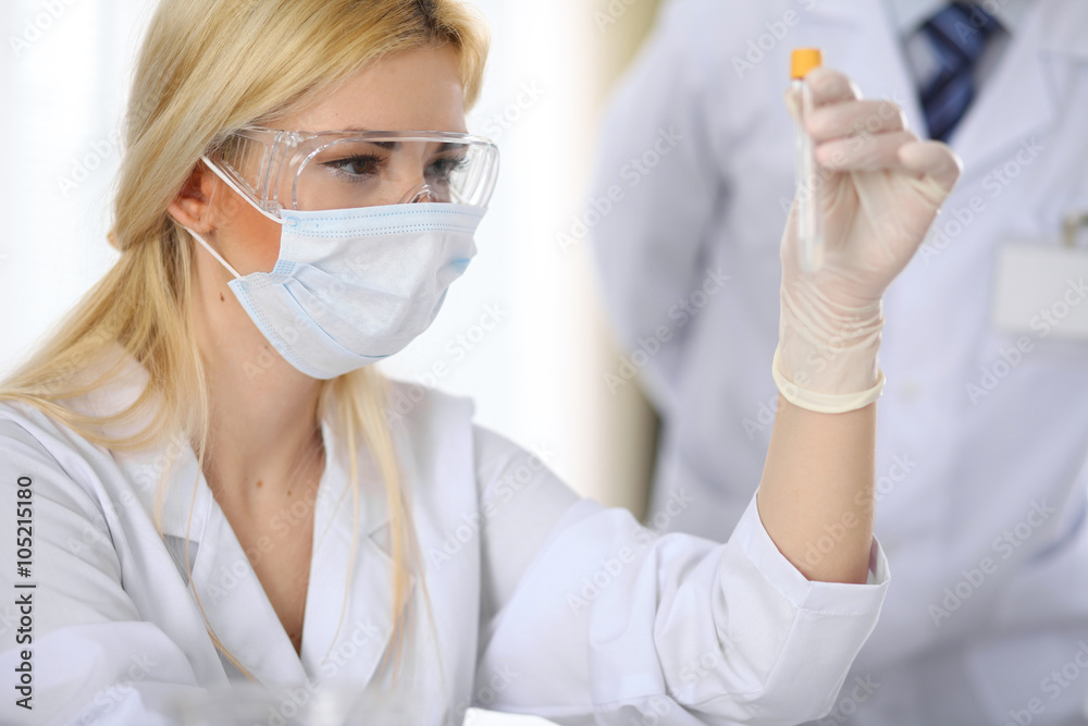 Scientific research team with clear solution in laboratory Scientific research team with clear solution in laboratory