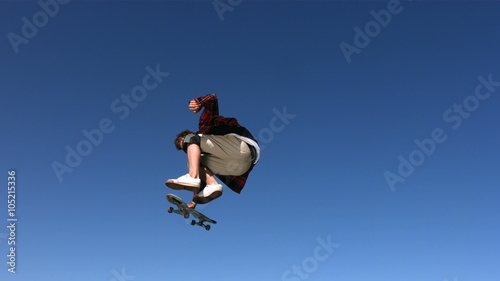 Skateboarder flying in air, slow motion