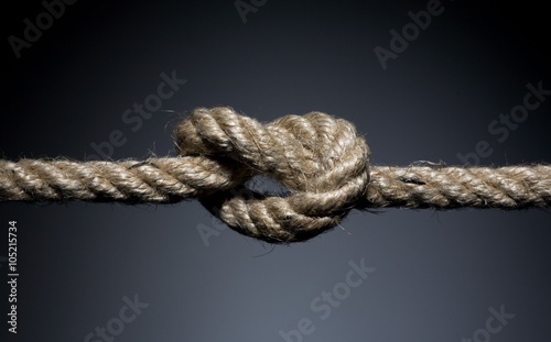 Frayed rope knot on a dark background