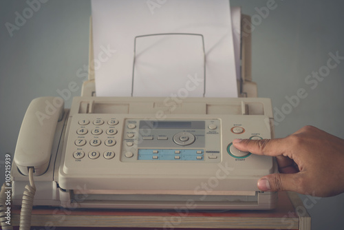 A hand pushing start button old fax retro style photo
