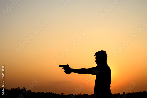 Silhoutte of a man with a handgun