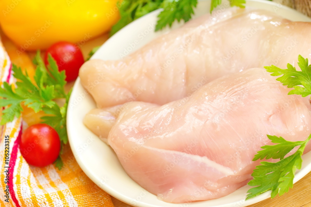 Raw chicken fillet with spices and vegetables Raw chicken fillet with spices and vegetables
