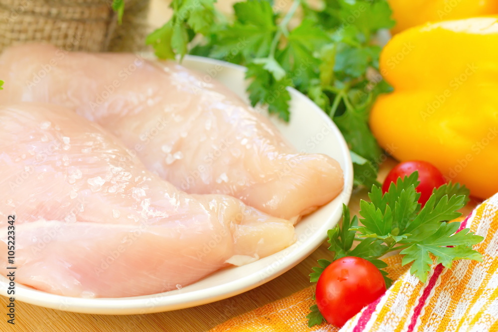 Raw chicken fillet with spices and vegetables Raw chicken fillet with spices and vegetables