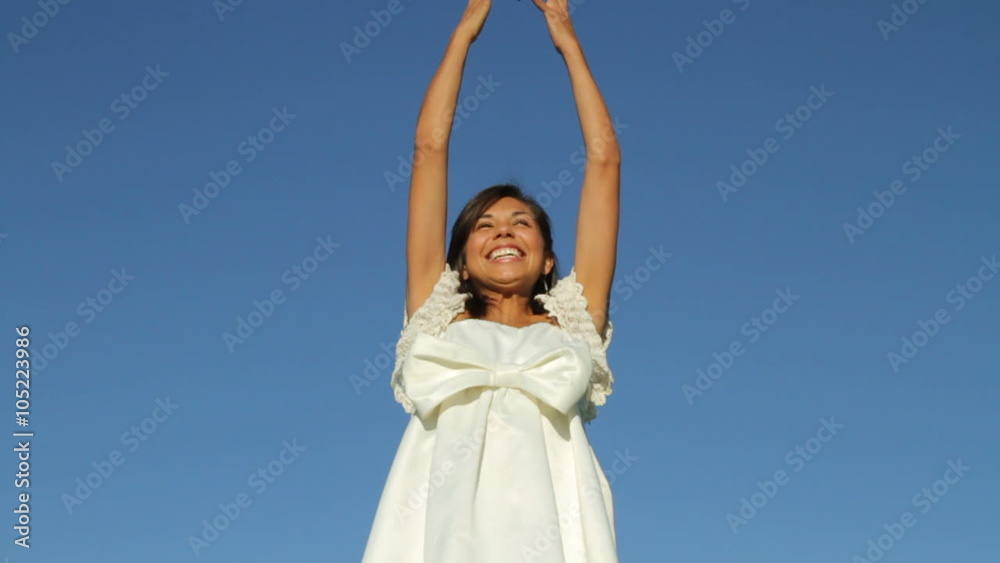 Bride throwing bouquet of flowers into sky Bride throwing bouquet of flowers into sky