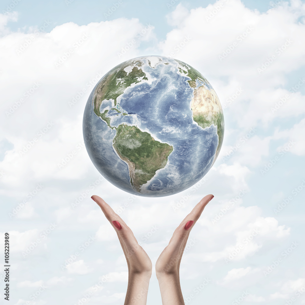 Earth in air over hands on background of sky and clouds. Environmental protection concept , care for planet Earth in air over hands on background of sky and clouds. Environmental protection concept , care for planet