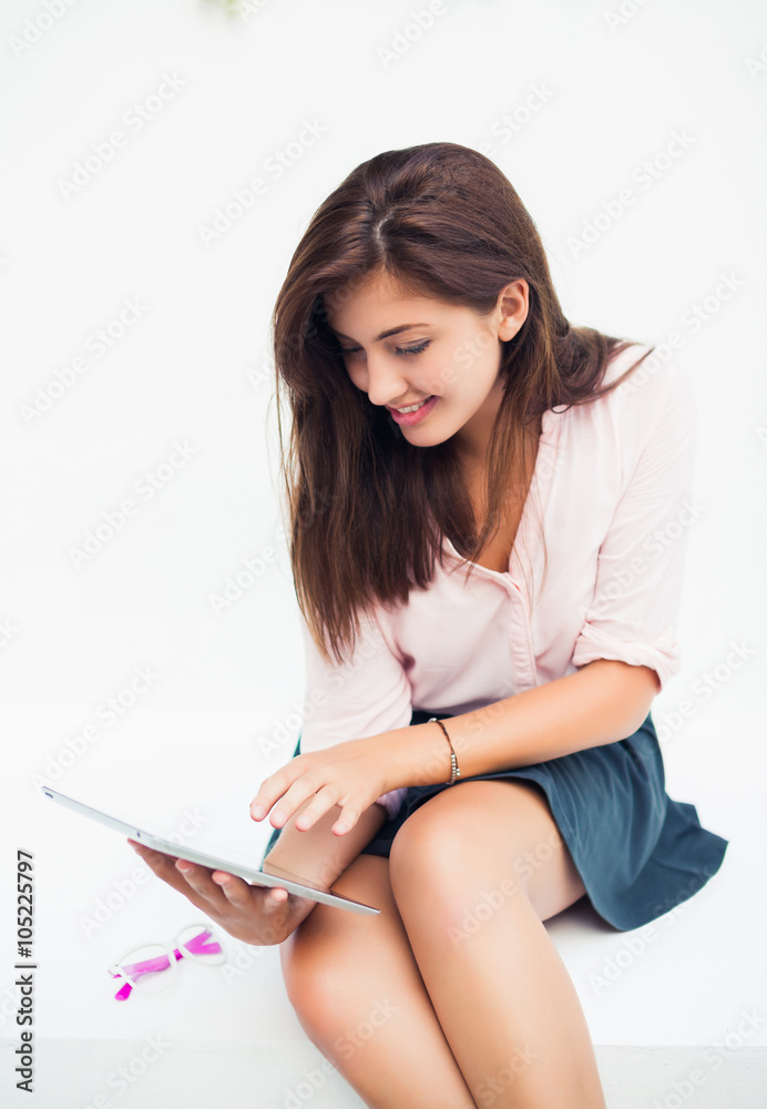 beautiful young woman in sunglasses sitting in a cafe drinking coffee/tea and work on your tablet on the Internet beautiful young woman in sunglasses sitting in a cafe drinking coffee/tea and work on your tablet on the Internet