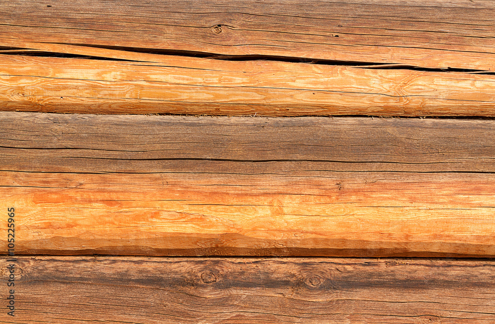 Wooden wall from logs as a background texture Wooden wall from logs as a background texture