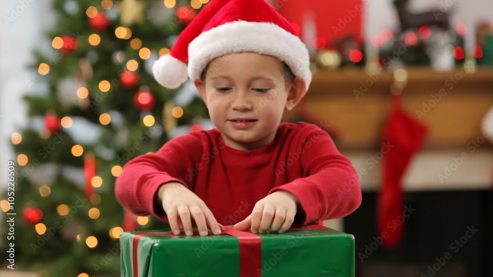 Young boy onpening present Young boy onpening present