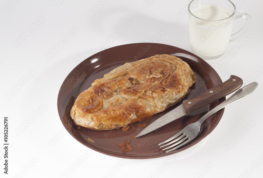 Nice fat and unhealthy breakfast. Burek and yogurt. Stock Photo | Adobe