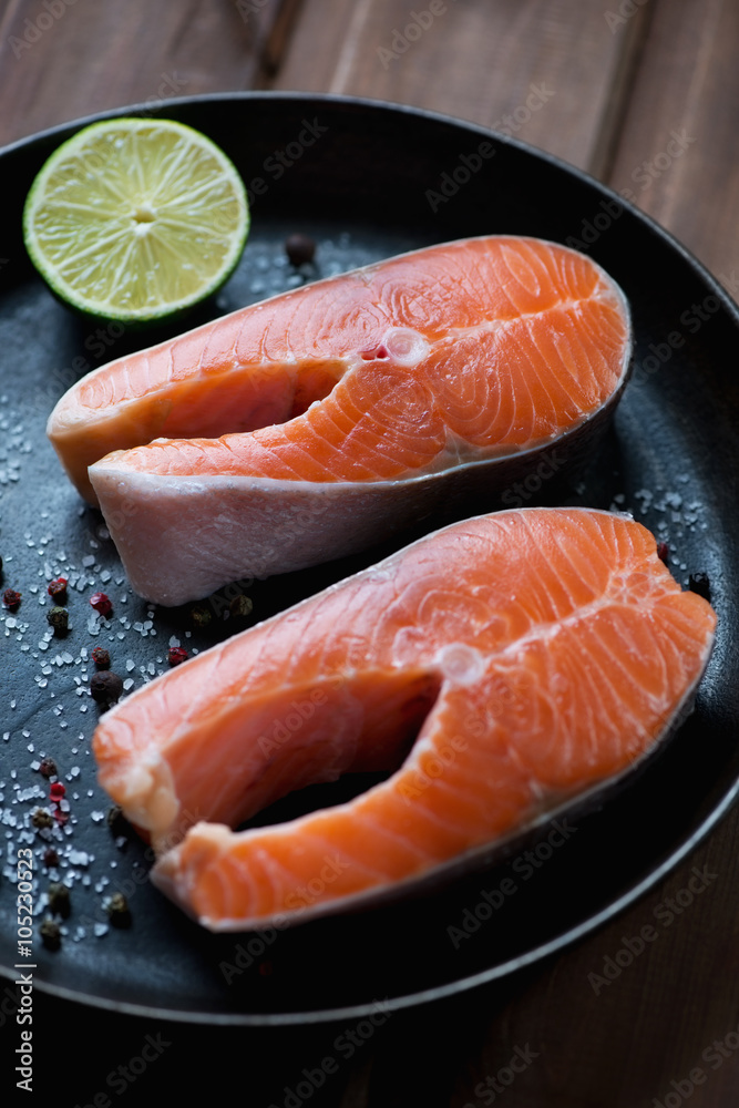 Frying pan with two fresh uncooked trout steaks, selective focus Frying pan with two fresh uncooked trout steaks, selective focus