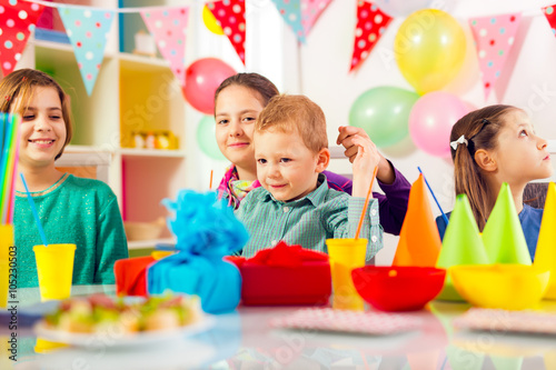 Group of adorable kids having fun at birthday party  selectiv focus