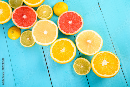 Lemon, Orange, Grapefruit And Lime Citrus Fruit Slices On Turquoise Table