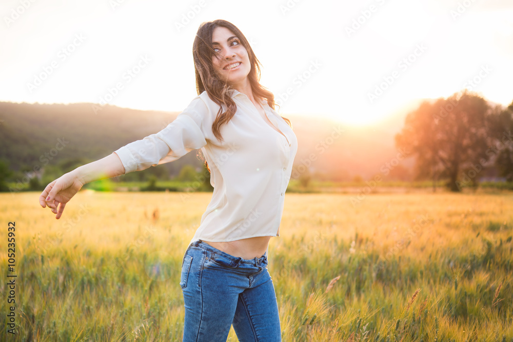 portrait of a beautiful woman in a field at the sunset portrait of a beautiful woman in a field at the sunset