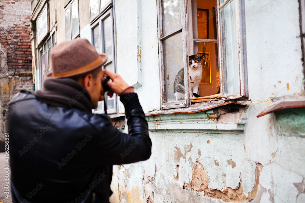 Man taking a picture of a cat Man taking a picture of a cat
