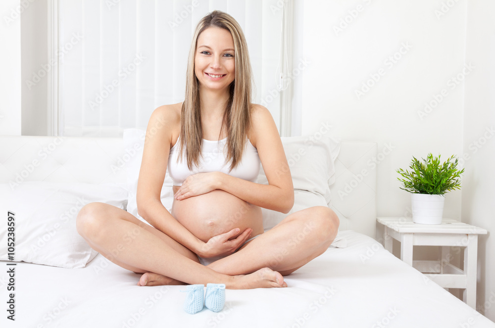 Pregnant woman relaxing on the bed Pregnant woman relaxing on the bed