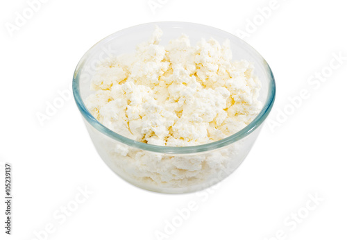 Cottage cheese in glass bowl on a light background