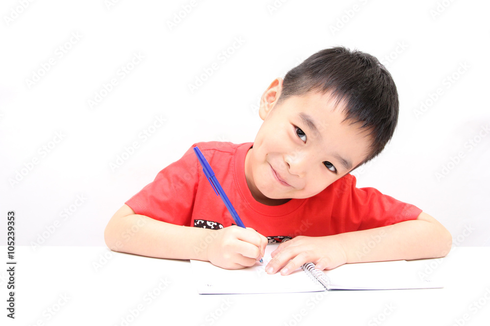 Inspired little boy at the table draw with crayons, isolated on Inspired little boy at the table draw with crayons, isolated on