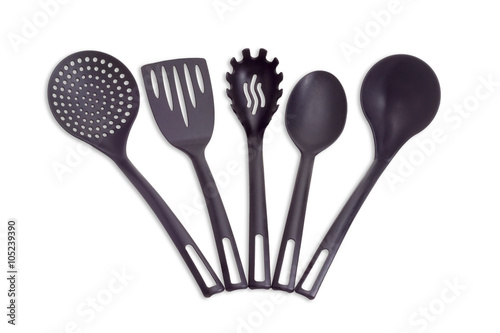Plastic black cooking utensils on a light background