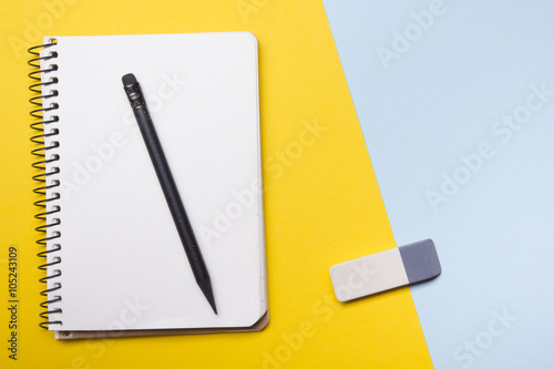 Office desk table with supplies top view. Notepad, pen and colorful paper. Copy space for text