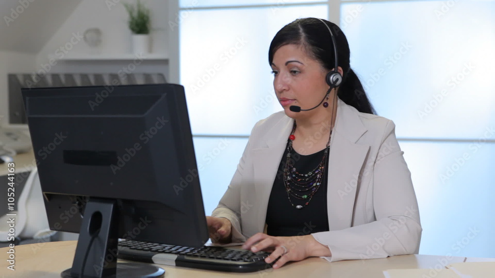 Portrait of business woman in office with headset