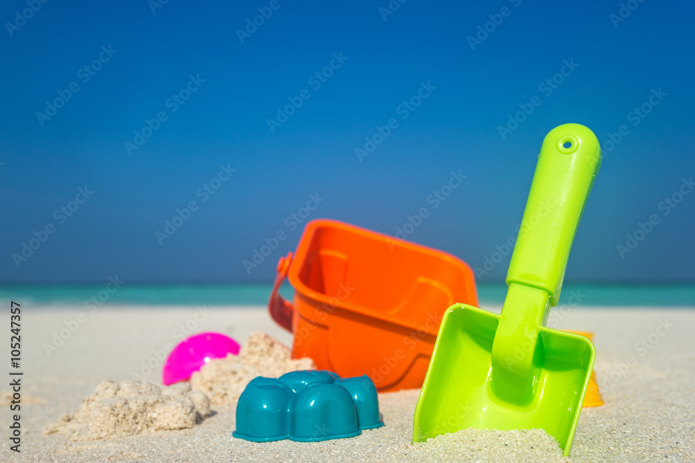 Beach toys in the sand at the beach Beach toys in the sand at the beach
