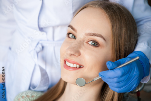 Dentist examining a patient s teeth