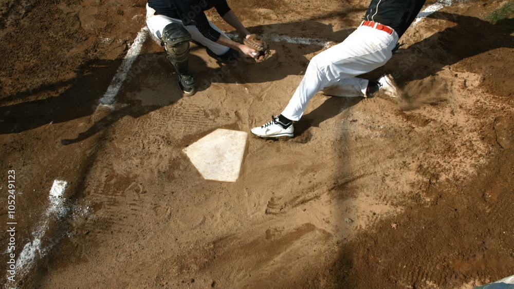 Overhead view of baseball player sliding into home plate