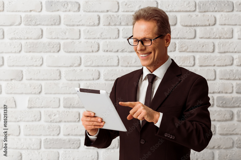 Middle aged businessman with gadget Middle aged businessman with gadget