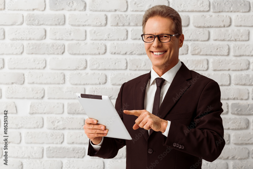 Middle aged businessman with gadget Middle aged businessman with gadget