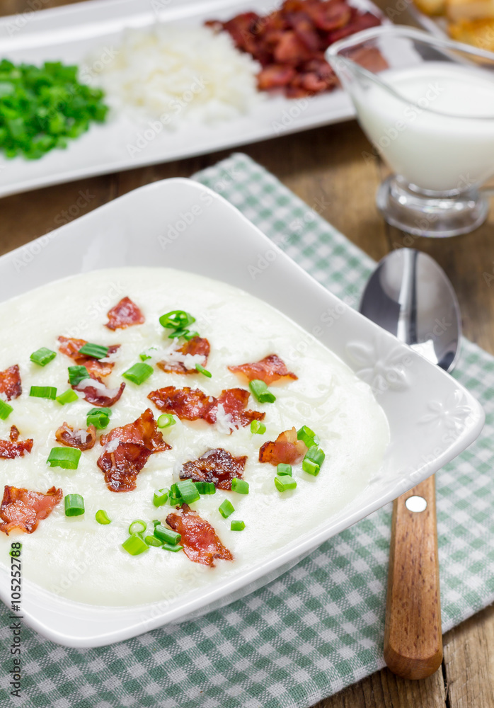 Creamy potato soup garnished with bacon and green onion Creamy potato soup garnished with bacon and green onion
