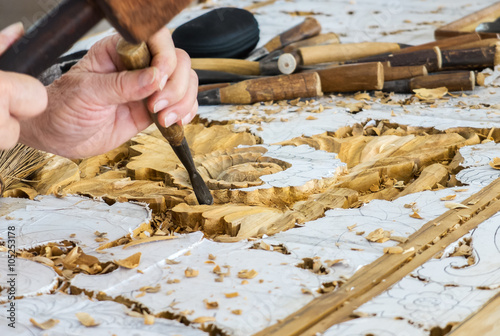 Hands of the Craftsman Working on Wooden Carving in Vintage Floral Pattern