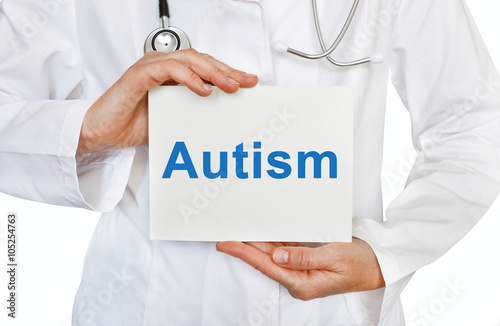 Doctor holding a card with Autism, Medical concept