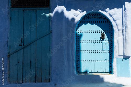 shadows and blue doors in the blue town of Chefchaouen photo