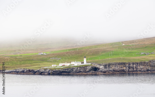 Bressay Lighthouse.  A view of Bressay lighthouse on the island of Bressay in the Shetland Isles, Scotland.  The lighthouse is located at Kirkabister Ness and overlooks Bressay Sound. photo