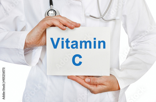 Doctor holding a card with Vitamin C, Medical concept photo