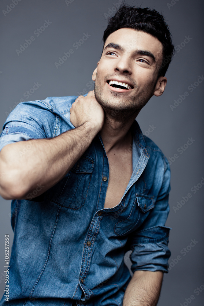 Fototapeta premium Portrait of handsome young man in casual denim clothes standing over white background