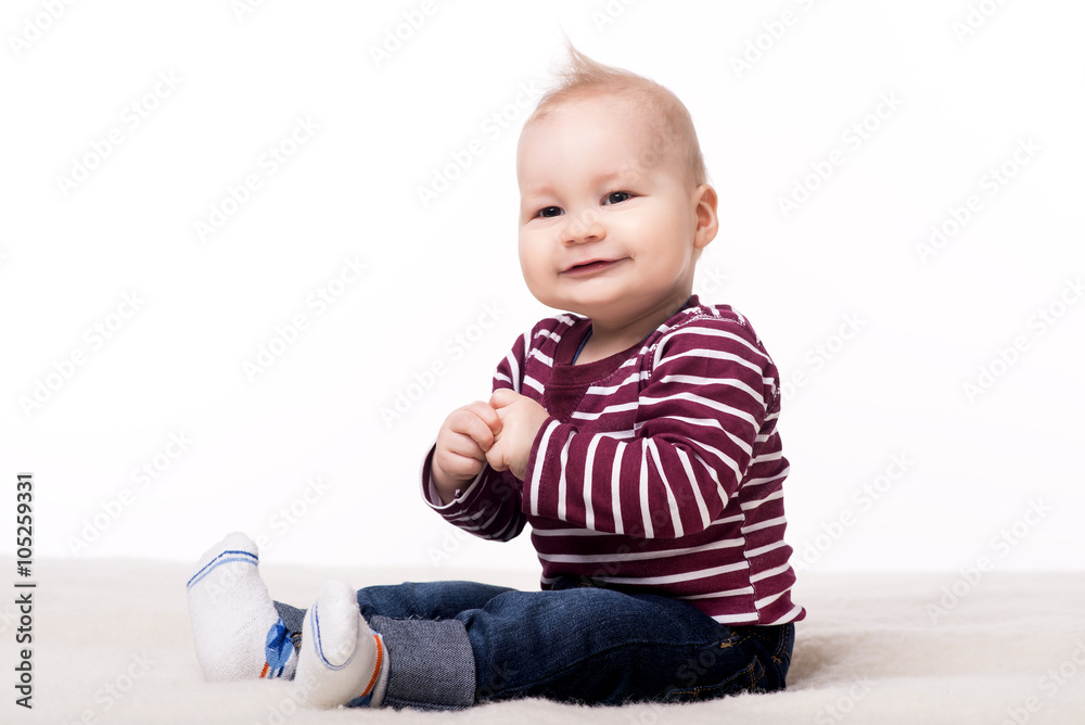 cute baby sitting on a blanket and looking at camera cute baby sitting on a blanket and looking at camera