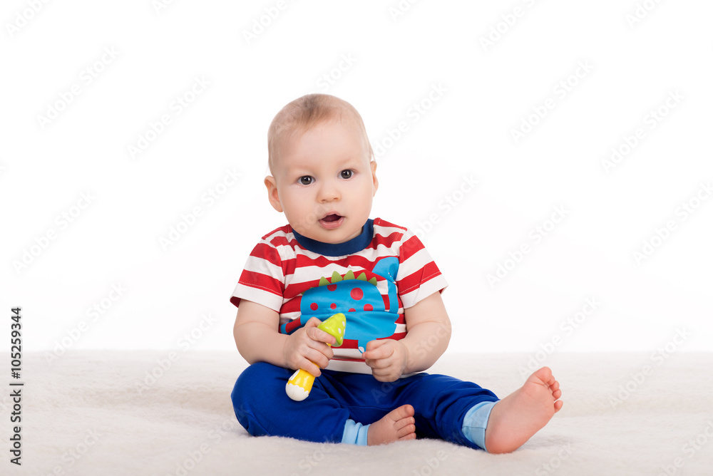 cute baby sitting on a blanket and looking at the camera cute baby sitting on a blanket and looking at the camera