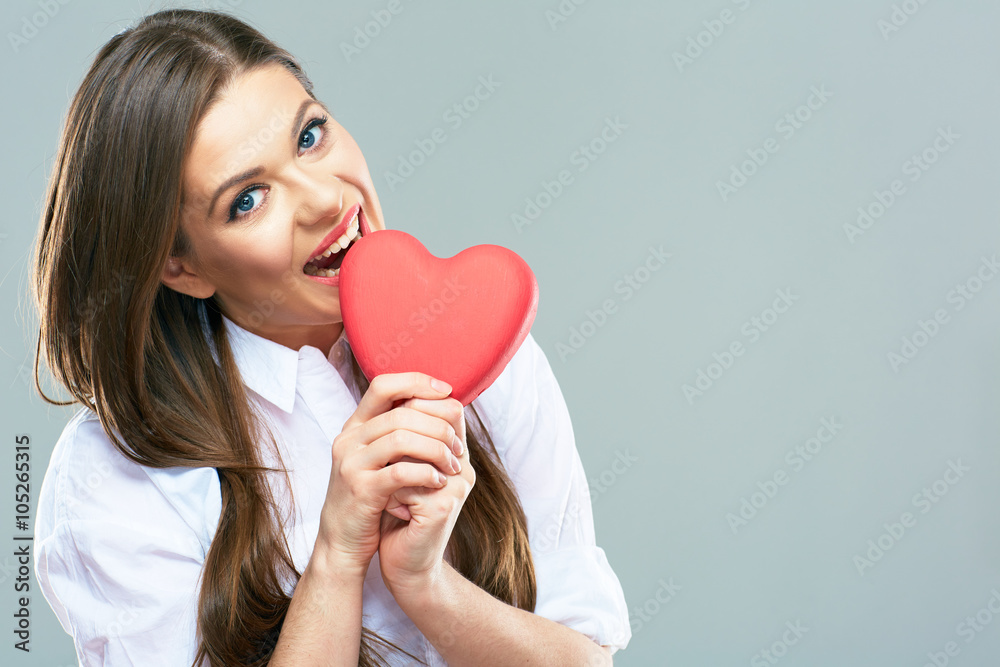Beautiful woman bite heart. Isolated portrait. Beautiful woman bite heart. Isolated portrait.